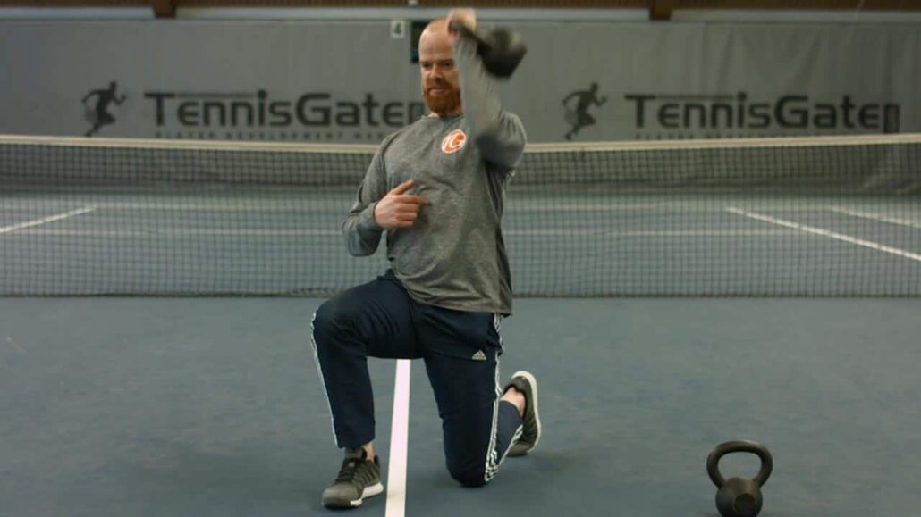 One-arm upside-down kneeling with kettlebell