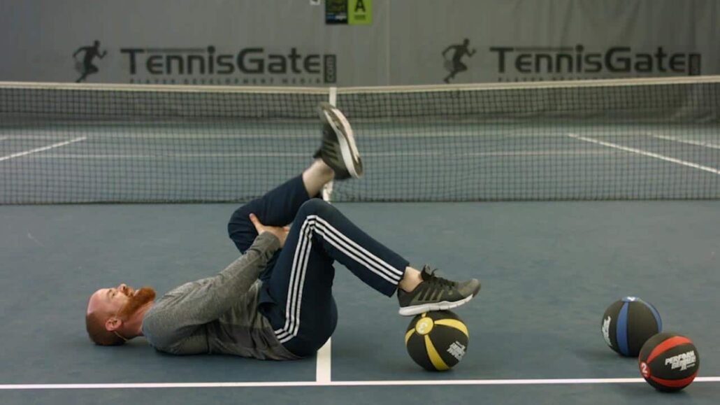 Training the back of the thigh with a medicine ball